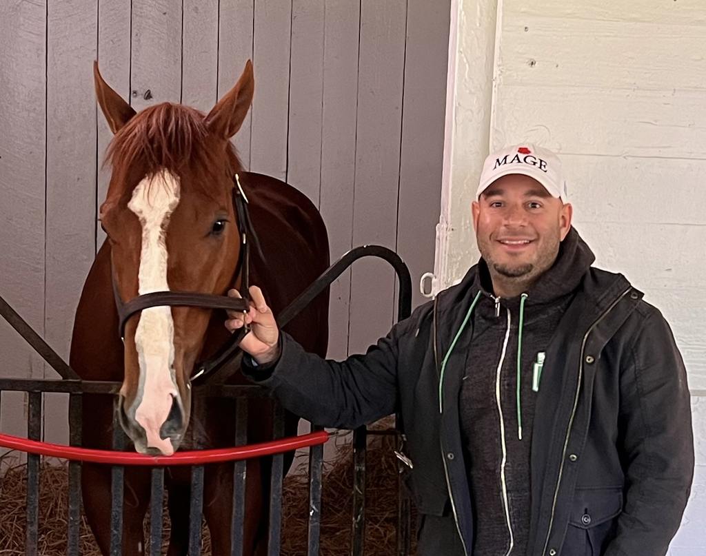 Ramiro Restrepo with his buddy, Mage, in the stall at the Pimlico Stakes Barn reserved for the Kentucky Derby winner. (Jim McCur/MJC)