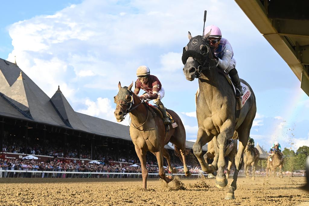 Arcangelo (pink cap inside) fights off an advancing Disarm for the Travers victory August 26.(Adam Coglianese)