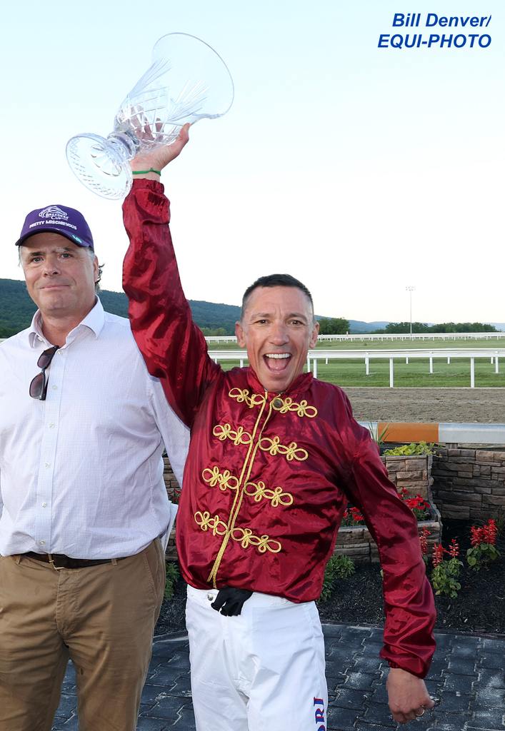 Jockey Frankie Dettori holds up the Penn Mile Trophy after guiding First World War to victory in the $400,000 Penn Mile at Penn National Racecourse on Friday May 31, 2024.  Photo By Bill Denver/EQUI-PHOTO