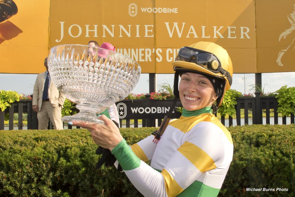 Sofia Vives hoists the hefty Oaks trophy. (Michael Burns Photo)