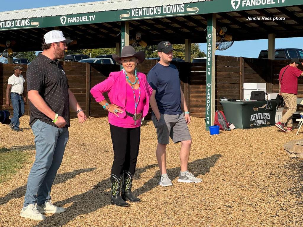 Judy Horton -- who runs Wyoming Downs' publicity, events and sponsorships as well as being the track's lobbyist -- oversees the trophy presentations in the paddock's winner's circle for every race at Kentucky Downs. (Jennie Rees photo)